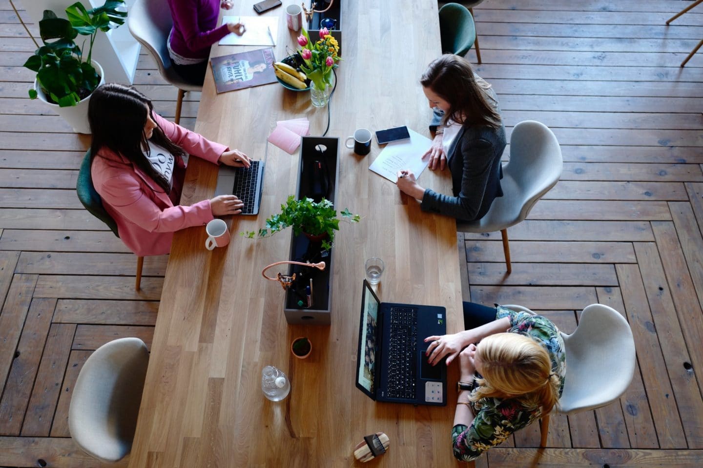 Women in business working at a table.